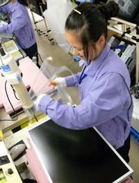 A plastic cover that protects the screen surface is removed and the LCD panel is then turned face down.
