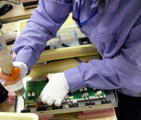 An inverter PCB (printed circuit board) is placed on the back of the LCD panel and affixed with an electric drill