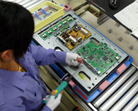 Once the LCD panel is encased inside the bezel, the power PCB and main PCB, manufactured by EIZO at a separate factory, are added.